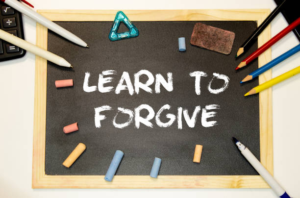 istock Text Learn to Forgive written with golden letters on a red heart. 1433693757