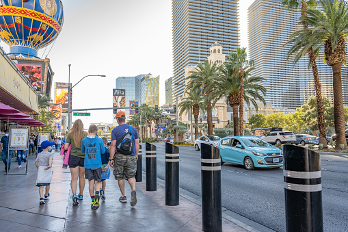 Las Vegas, NV - circa November, 2021: A family walks along Las Vegas Boulevard on a nice day.