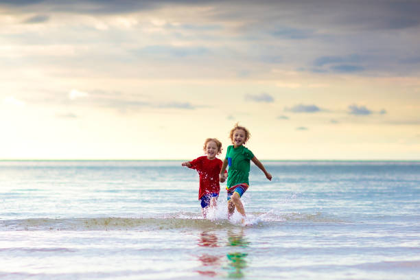 Kids play on tropical beach. Sand and water toy. Child playing on tropical beach. Little baby boy at sea shore. Family summer vacation. Kids play with water and sand toys. Ocean and island fun. Travel with young children in Asia. family beach vacations travel stock pictures, royalty-free photos & images