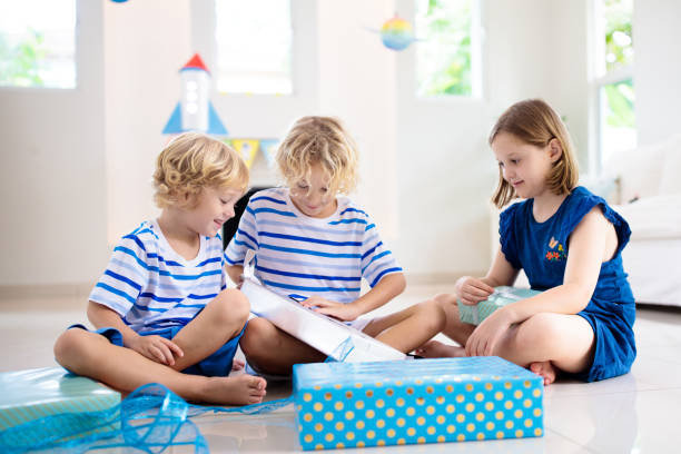 istock Space theme kids birthday party. Boy with present. 1433699889