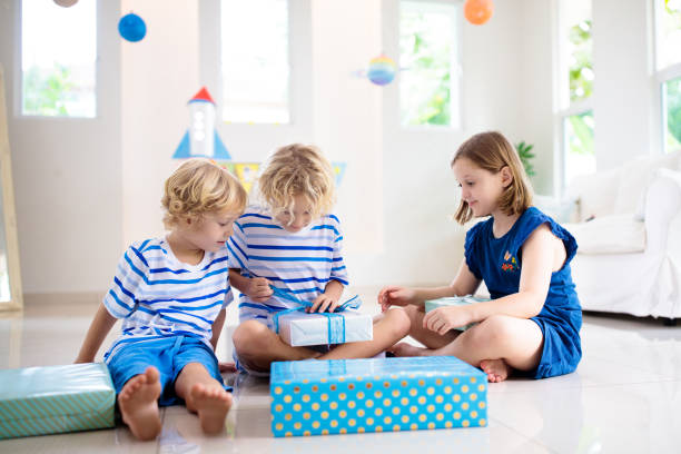istock Space theme kids birthday party. Boy with present. 1433700464