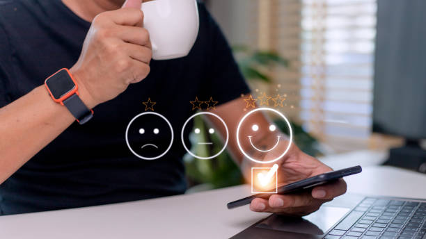 istock Customer service evaluation concept. using a smartphone is pressing face emoticon smiling in satisfaction on virtual touch screen. 1433700877