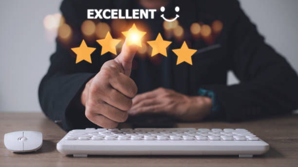 istock customer hand  with gold five star rating feedback icon and press level excellent rank for giving best score point to review the service, business concept 1433700913