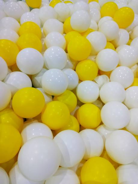 istock A collection of yellow and white balls 1433710421