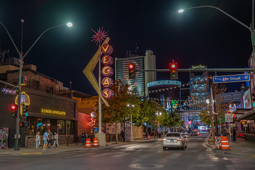 Las Vegas, NV - November 21, 2021: View of famous Fremont Street at night, with the historic Vegas Neon sign in focus above.
