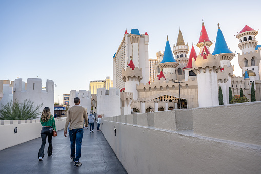 Las Vegas, NV - November 24, 2021: A young couple explores the pedestrian bridges at the Excalibur Hotel and Casino on the Las Vegas Strip.