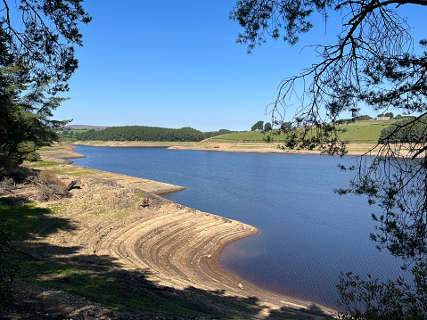 very low water levels in a fresh water reservoir in Yorkshire, England UK during the summer drought of 2022