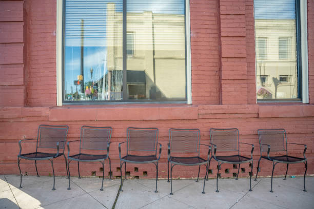 old armchair with a metal frame and a torn rattan seat stands outdoor