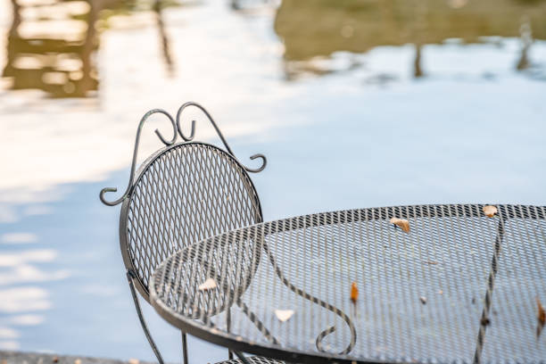 Iron dining set by a peaceful lake. stock photo
