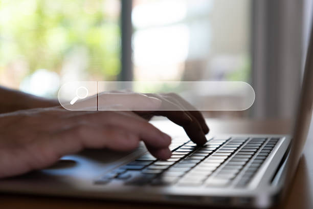 istock Selective focus at the search box with blurred background of men hand holding digital tablet or laptop computer with internet router while search for information from internet and website 1433732530