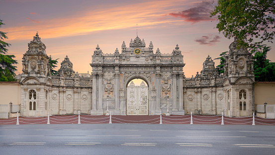 Sunset shot of closed gate leading to former Ottoman Dolmabahce Palace, or Dolmabahce SarayÄ±, suited in Ciragan Street, Besiktas district, Istanbul, Turkey
