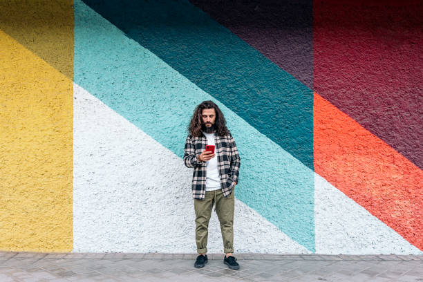 istock Hipster Man Typing in his Phone 1433746927