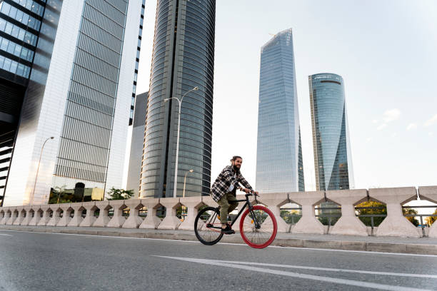 Free Stock Photo of Man Riding Bike in Front of Large Building ...