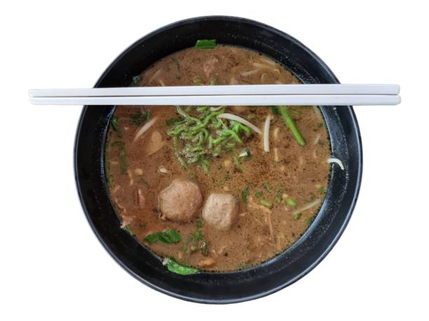 Chopsticks put on a bowl of jade noodles. isolate white background.