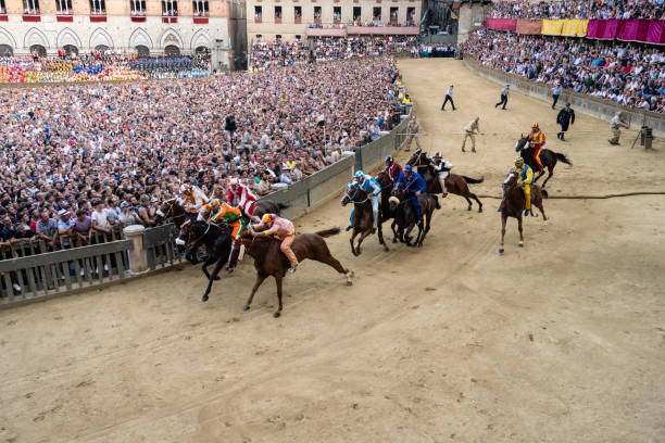 Palio di Siena Horse Race Start at the Mossa Siena, Tuscany, Italy - August 17 2022: Palio di Siena Horse Race Start at the Mossa on the Piazza del Campo. derby city stock pictures, royalty-free photos & images