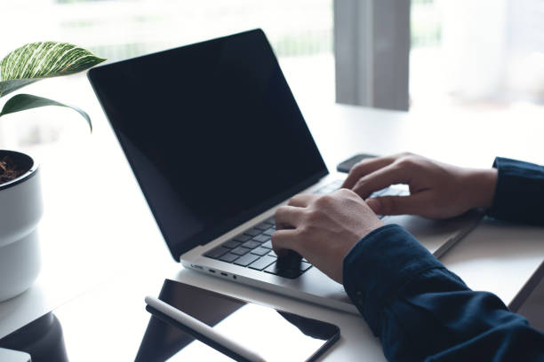 istock Businessman working on laptop computer at home office. Casual business man, freelancer using portable computer devices, surfing the internet networking on table at workplace 1433753946