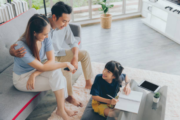 istock Cheerful asian parent dad and mom teaching daughter studying doing homework, Education concept 1433754238
