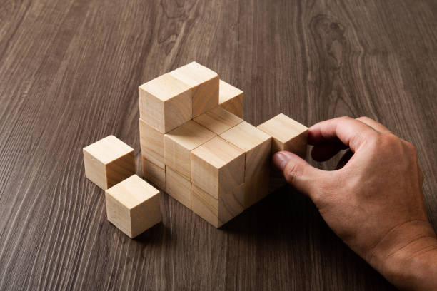 istock Business strategy conceptual idea. Human hand builds stack of wooden blocks. 1433754783