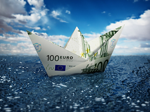 100 Euro bill paper ship floating on the water. Financial risk concept.