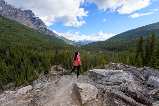 A woman standing on the rock with Beautiful View of Canadian Mountain Landscape