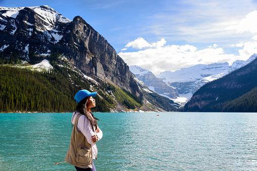 Female hiker enjoying the beautiful view of  Lake Louise Banff National Park, Canada