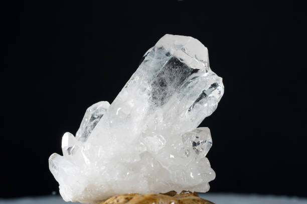 istock Quartz with mineral crystals against a black background 1433760491