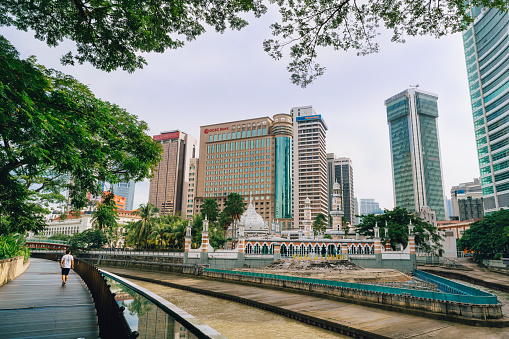 Masjid Jamek mosque with business building in Kuala Lumpur, Malaysia capital city