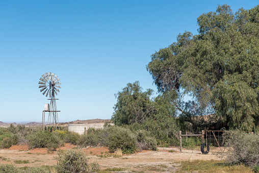 A windmill, watertank and concrete dam on the road between Loxton and Fraserburg in the Northern Cape Karoo