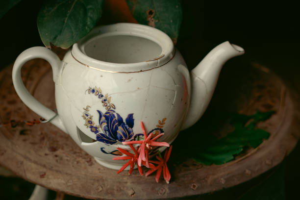 istock Broken porcelain tea kettle decorated with flowers 1433763755