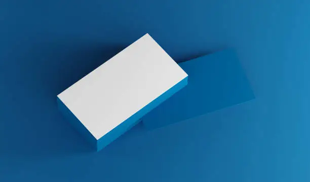 Photo of Blank business cards mockup over a blue background.