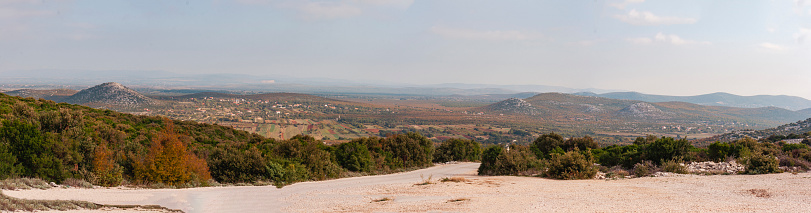Panorama of Dalmatian landscape from a hill. Vrana lake, villages, hills, karst landscape.