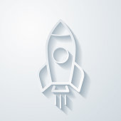 istock Rocket. Icon with paper cut effect on blank background 1433767174