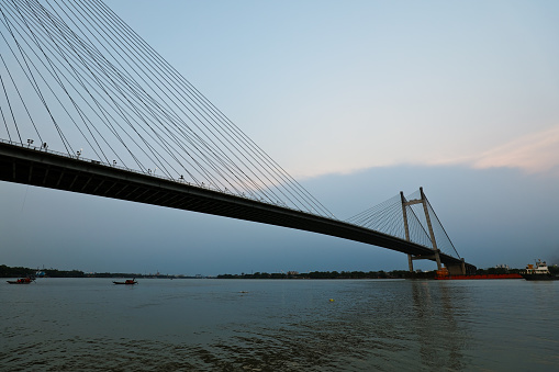 Second Howrah Bridge over the river hoogly in kolkata west Bengal India. Evening sky with cloudy sky.