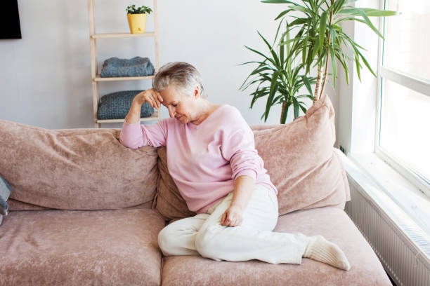 istock middle aged lady looking away sit alone at home feel anxious lonely, sad 1433770072
