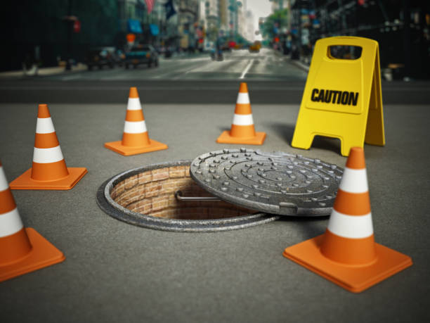 istock Half open sewer lid or manhole cover with traffic cones and caution signboard 1433770191
