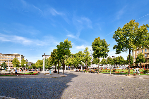Mannheim, Germany - September 2022: Part of public park called 'Friedrichsplatz' and Mannheim city center on sunny day