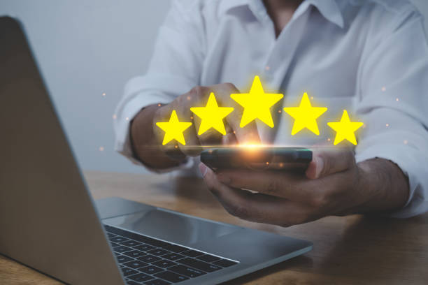 istock business man using mobile smart phone and laptop computer with five star button to review good rating, digital marketing, good experience, customer product rating review, customer feedback concept 1433779432