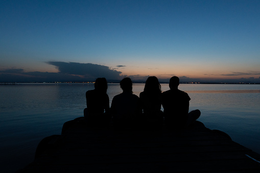 two young couples enjoying the sunset in the albufera natural park, Valencia