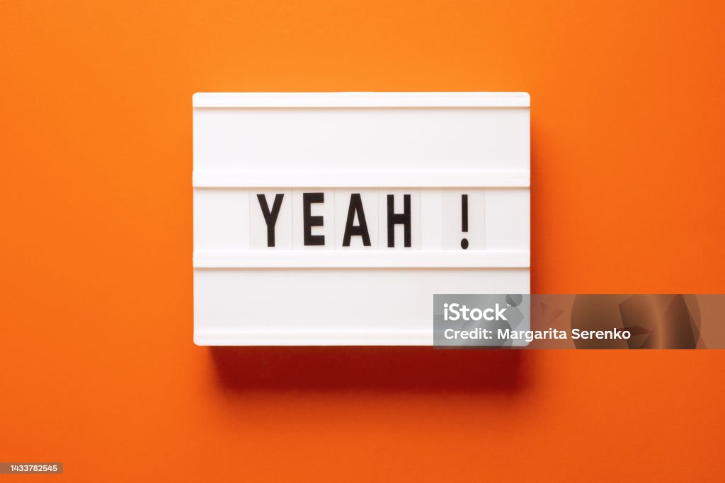Lightbox with word yeah on orange background, top view. Space for text Agreement Stock Photo