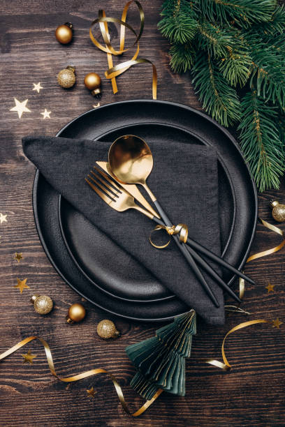 istock Christmas table setting black plates and gold decor 1433783275