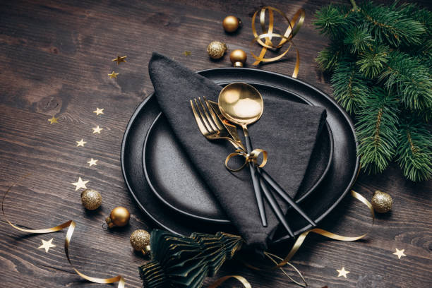 istock Christmas table setting black plates and gold decor 1433783288