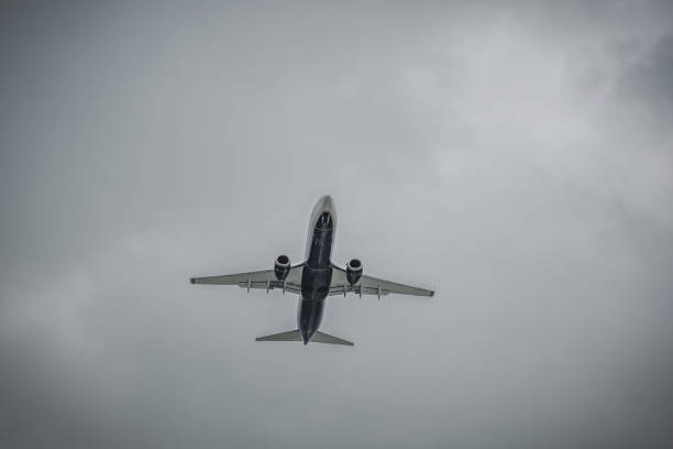 istock Jet liner flying against the background of rain clouds 1433784017