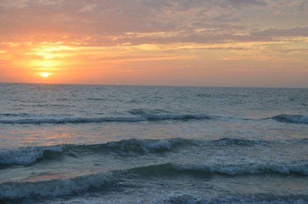 istock Beautiful golden sunset reflected in the sea waves 1433784723