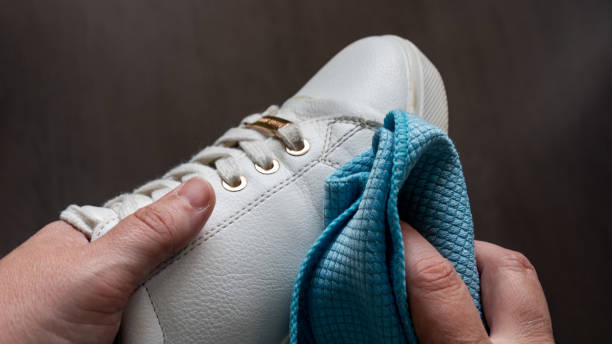 istock Hands cleaning a white sneaker, with out of focus background 1433785884