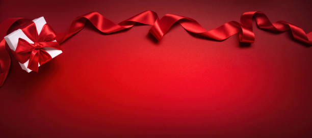istock Gift and ribbon on red background 1433787750