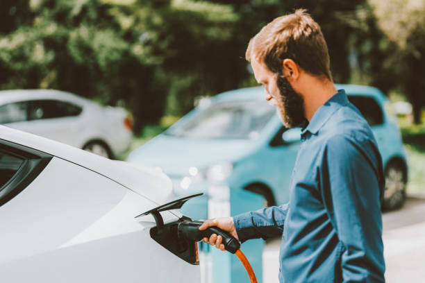 istock Man charging electric car 1433789417
