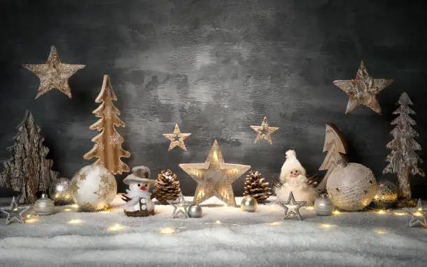 Christmas decoration set with gray stylish background and copy-space, hanging stars and bright ornaments and lights on snow
