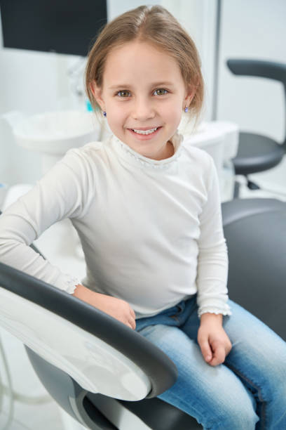 istock Joyous little patient sitting in dentist office after teeth examination 1433792624