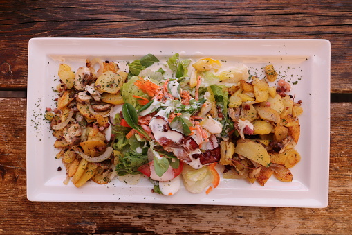 a delicious salad with fried potatoes