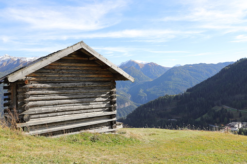 Traditional house among the meadows of the high Gressoney Valley, one of the several valleys belonging to the Aosta Valley, a mountainous semi-autonomous region in northwestern Italy. The valley was inhabited at the end of the Middle Ages by Walser, native peoples in the Upper Valais, which have left traditions and a popular architecture still visible today. Valle d'Aosta, Italy